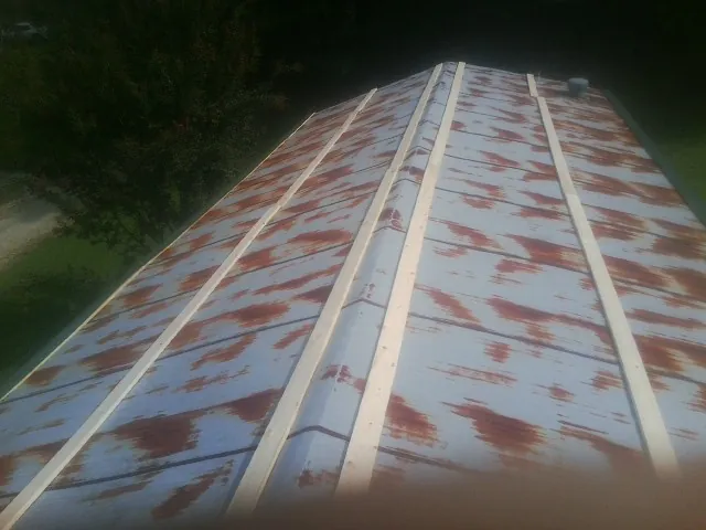 Rusted metal roof panels with new wood purlins before replacement — Storm Damage Roof Repair in Birds Landing by Roofing Brothers
