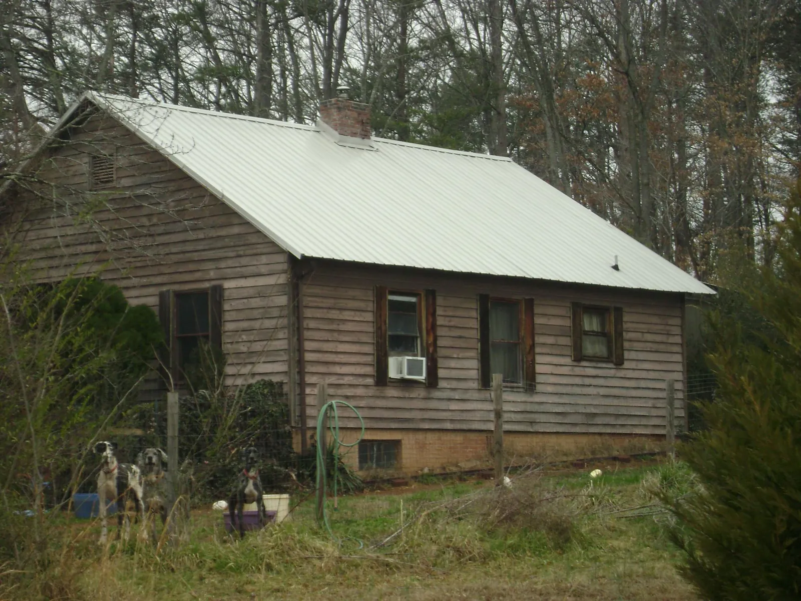 White metal roof on an old wood sided farmhouse, from a Metal Roof Installation job in Birds Landing